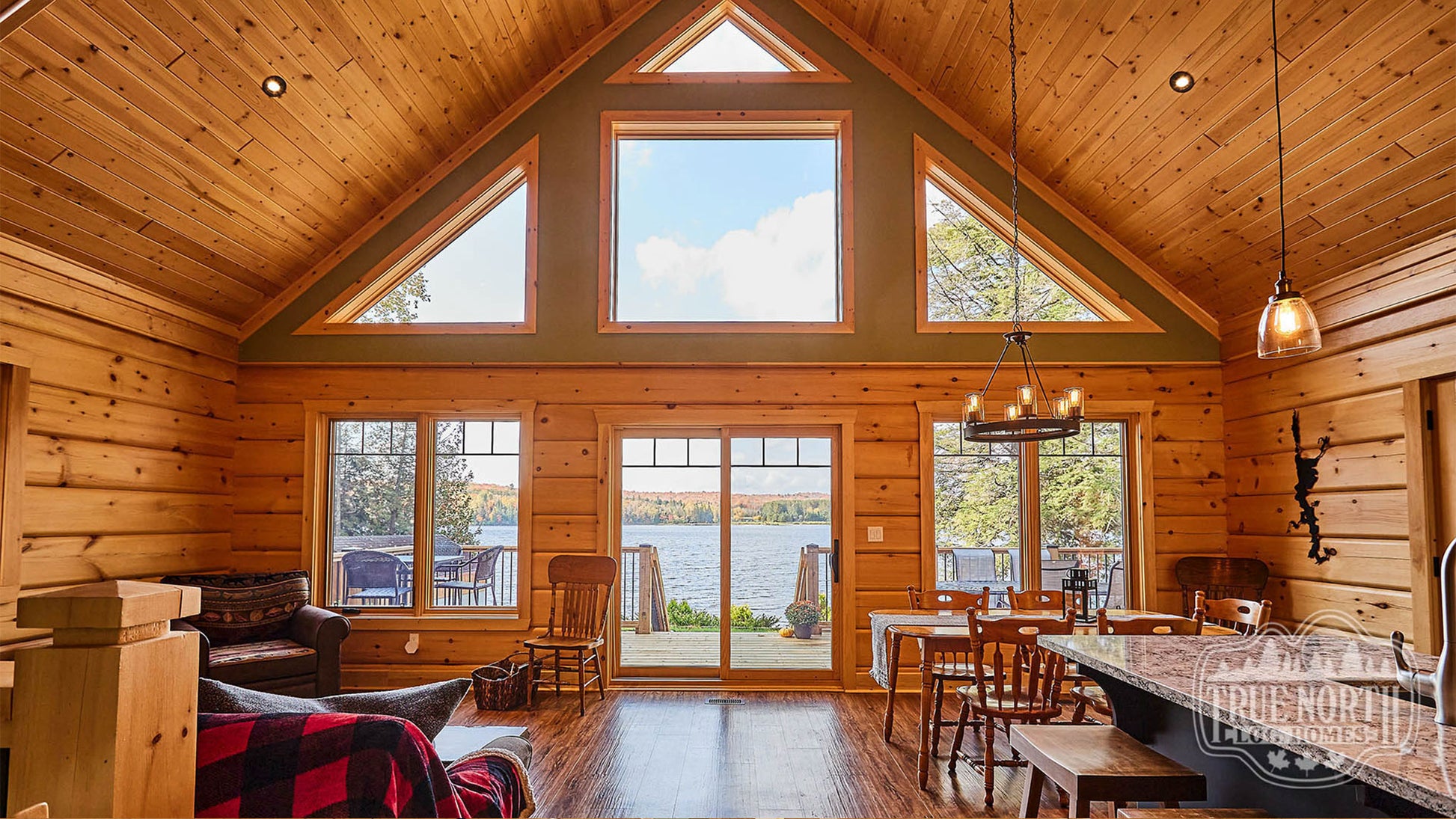 Arrowhead two-storey Canadian log home with cathedral ceilings and floor-to-ceiling windows - Interior Main Room facing lake