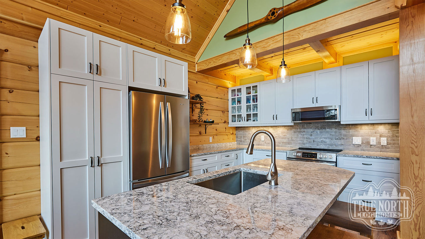 Arrowhead two-storey Canadian log home with cathedral ceilings and floor-to-ceiling windows - Kitchen
