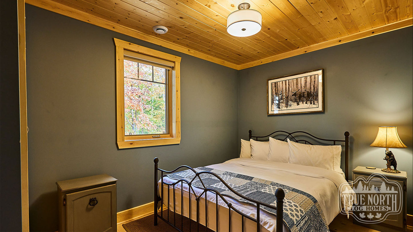 Arrowhead two-storey Canadian log home with cathedral ceilings and floor-to-ceiling windows - Master Bedroom