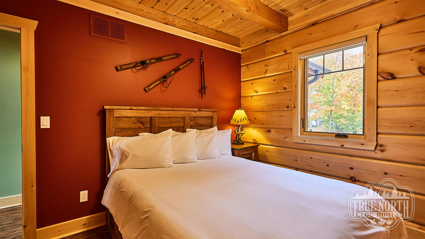 Arrowhead two-storey Canadian log home with cathedral ceilings and floor-to-ceiling windows - Double Bedroom