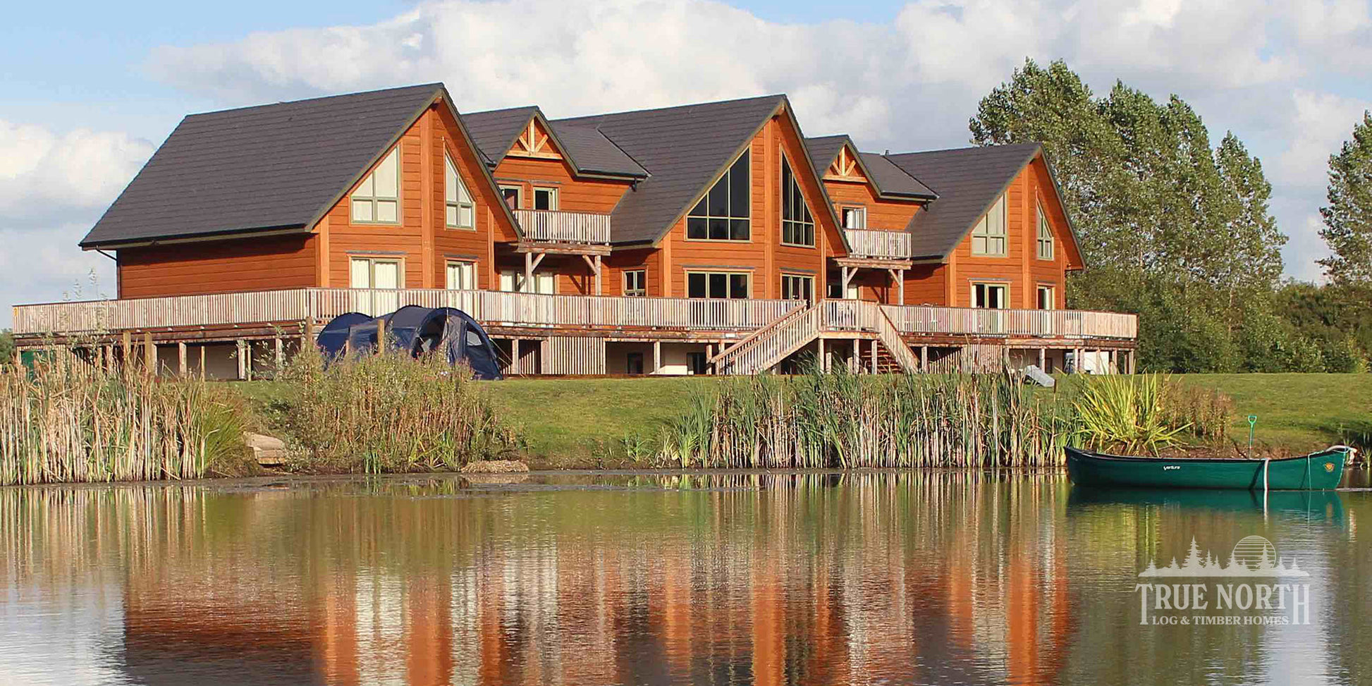 Alaskan commercial Canadian log building by True North Log Homes built for Foundation Matters charity - Exterior over lake