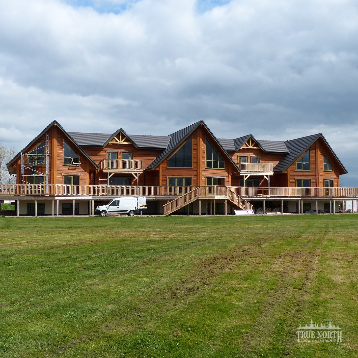Alaskan commercial Canadian log building built for Foundation Matters charity - Front Aspect across fields