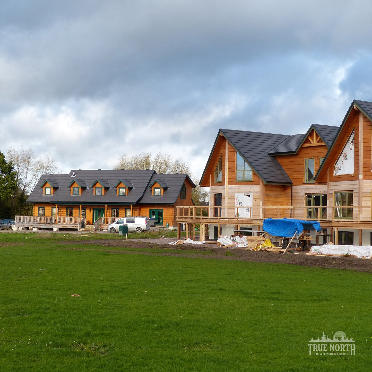 Louisburg traditional Canadian log home designed for family living in Derbyshire - With sister Alaskan in the foreground