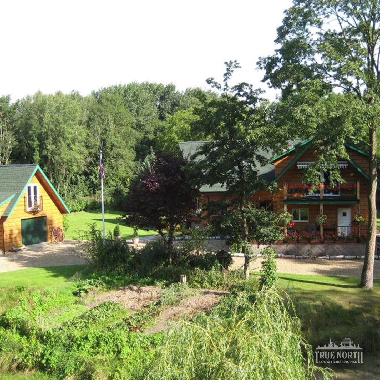 Norfolk luxury Canadian log home by True North Log Homes, set within a woodland setting in Norfolk – home and detached garage with studio.